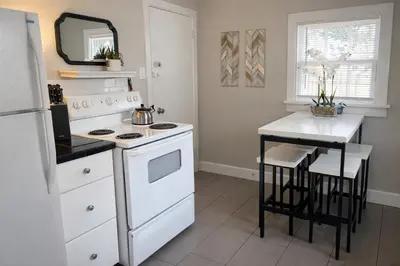 a kitchen with a white stove and a white refrigerator at Beautiful Bungalow Next to UNC - Free Cruiser Bikes! in Greeley
