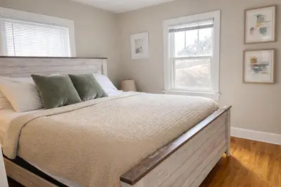 a bedroom with a large bed and a window at Beautiful Bungalow Next to UNC - Free Cruiser Bikes! in Greeley