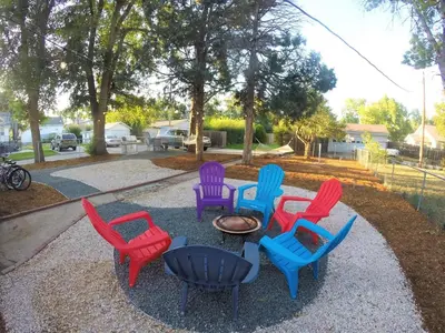a group of colorful chairs sitting around a table at Beautiful Bungalow Next to UNC - Free Cruiser Bikes! in Greeley