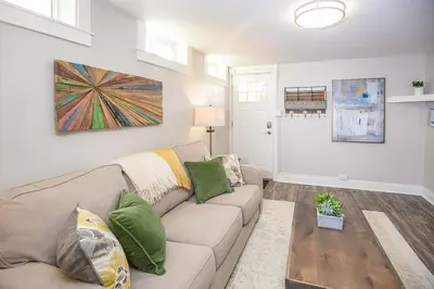 a living room with a couch and a table at Cozy Retreat - Walk to UNC - Free Cruiser Bikes in Greeley