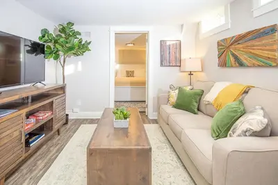 a living room with a couch and a tv at Cozy Retreat - Walk to UNC - Free Cruiser Bikes in Greeley