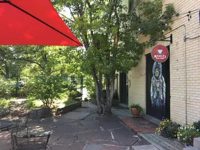a red umbrella sitting in front of a building at Cozy Carriage House - Walk to UNC + Free Bikes in Greeley