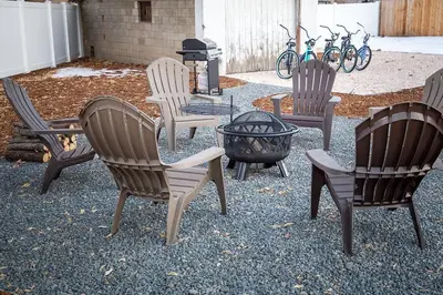 a group of chairs sitting around a fire pit at Cozy Carriage House - Walk to UNC + Free Bikes in Greeley