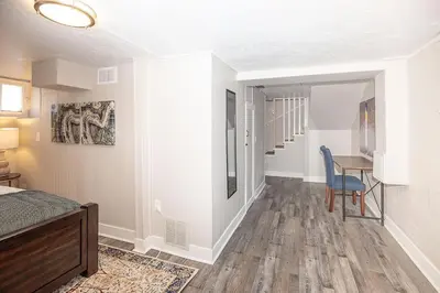 a bedroom with a bed and a desk and a table at Cozy Carriage House - Walk to UNC + Free Bikes in Greeley