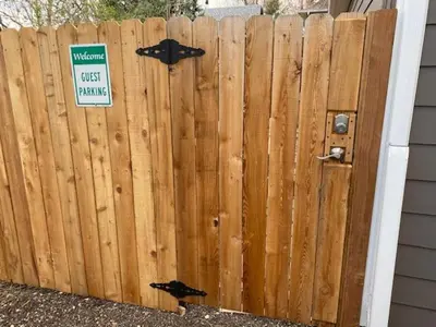 a wooden fence with a sign on it at The Chic Guest Retreat in Old Town near CSU in Fort Collins