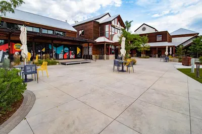 a patio with chairs and tables in front of a building at The Chic Guest Retreat in Old Town near CSU in Fort Collins