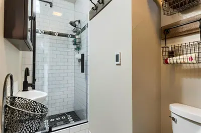 a bathroom with a shower with a toilet and a sink at The Chic Guest Retreat in Old Town near CSU in Fort Collins