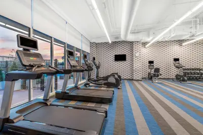 a gym with treadmills and ellipticals in a building at Aloft Denver North Westminster in Westminster