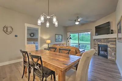 a dining room and living room with a wooden table and chairs at Fraser Retreat, Walk to Ski Shuttle and Main St in Fraser