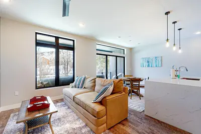 a living room with a couch and a kitchen at River West 811 in Silverthorne
