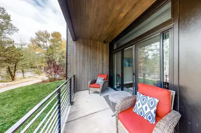 a screened porch with two chairs and a table at River West 811 in Silverthorne
