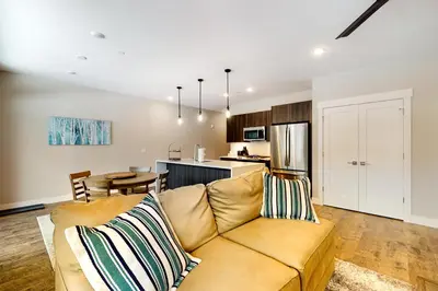 a living room with a couch and a kitchen at River West 811 in Silverthorne