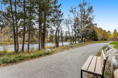 a wooden bench sitting on the side of a road at River West 811 in Silverthorne