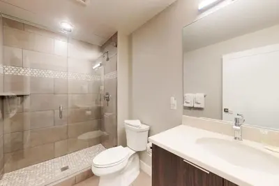 a bathroom with a toilet and a sink and a shower at River West 811 in Silverthorne
