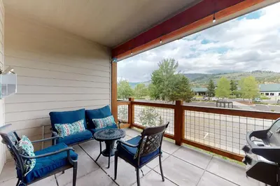 a balcony with chairs and a table and a view at Riverfront Retreat in Silverthorne