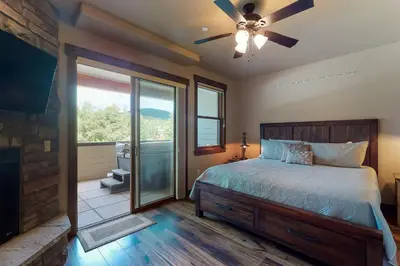 a bedroom with a bed and a ceiling fan at Riverfront Retreat in Silverthorne