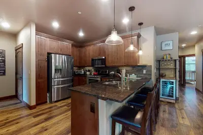 a large kitchen with wooden cabinets and a counter top at Riverfront Retreat in Silverthorne