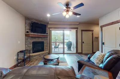 a living room with a couch and a fireplace at Riverfront Retreat in Silverthorne