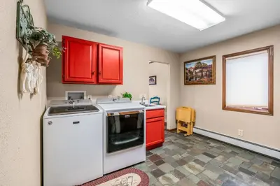 a kitchen with red cabinets and a white stove at Heavenly Pines -- EV #3361 home in Estes Park