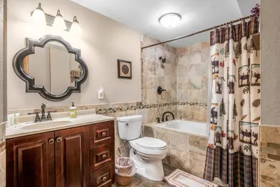 a bathroom with a toilet and a sink and a tub at Heavenly Pines -- EV #3361 home in Estes Park