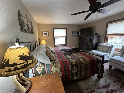 a bedroom with a bed and a ceiling fan at Heavenly Pines -- EV #3361 home in Estes Park