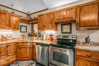 a kitchen with wooden cabinets and a stove at Heavenly Pines -- EV #3361 home in Estes Park