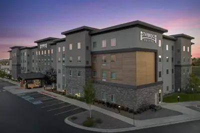 a rendering of a hotel building with a parking lot at Staybridge Suites - Denver North - Thornton by IHG in Thornton