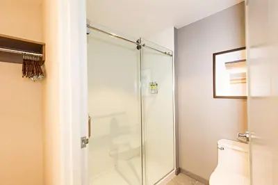 a bathroom with a shower with a toilet at Staybridge Suites - Denver North - Thornton by IHG in Thornton