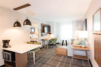 a living room with a kitchen and a living room with a couch at Staybridge Suites - Denver North - Thornton by IHG in Thornton
