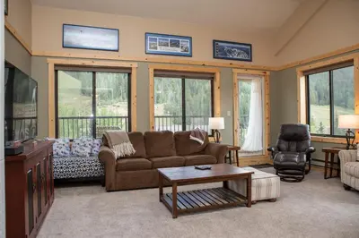 a living room with a couch and a table at 2800 Slopeside condo in Keystone
