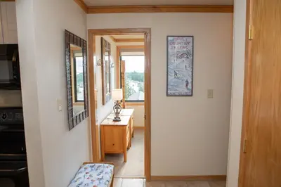 a hallway with a door leading into a room with a table at 2800 Slopeside condo in Keystone