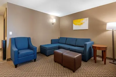 a waiting room with blue chairs and a couch at Comfort Suites Broomfield-Boulder-Interlocken in Broomfield