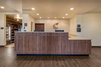 a lobby with a reception desk in a building at Comfort Suites Broomfield-Boulder-Interlocken in Broomfield