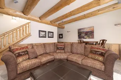 a living room with a couch and a table at Dreamcatcher at Lakota home in Winter Park