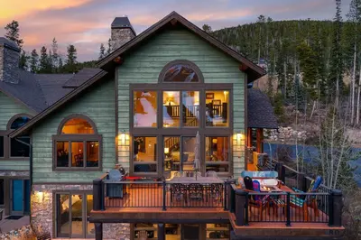 a house with a deck with a table and chairs at Dreamcatcher at Lakota home in Winter Park