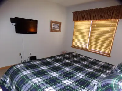 a bedroom with a bed and a flat screen tv at Black Bear 2 Bed 2 Bath BBCS in Dillon