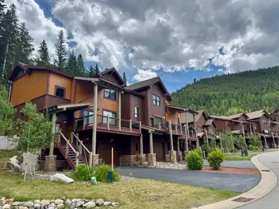 a large building with a road in front of it at Alders 46 by SummitCove Lodging in Keystone