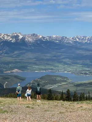 a group of three people standing on top of a mountain at Alders 46 by SummitCove Lodging in Keystone
