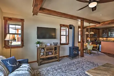 a living room with a couch and a stove at Fraser Condo with Views and Hot Tub Near Winter Park! in Fraser