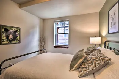 a bedroom with a bed and a window at Fraser Condo with Views and Hot Tub Near Winter Park! in Fraser