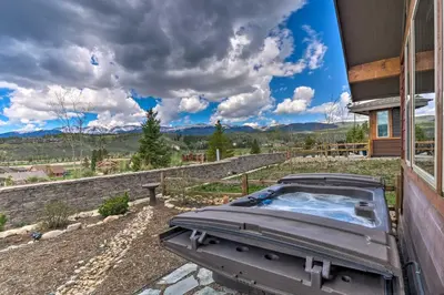 a hot tub on the side of a house at Fraser Condo with Views and Hot Tub Near Winter Park! in Fraser