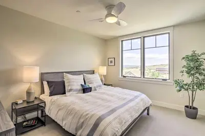 a bedroom with a large bed and a window at Winter Park Condo with Fireplace - 4 Mi to Slopes! in Winter Park