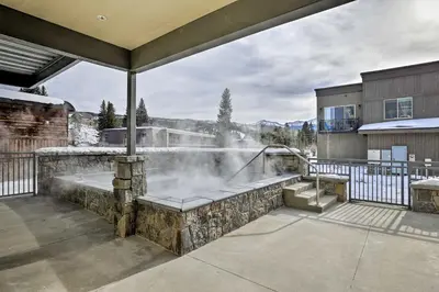 a hot tub on a patio with a fountain at Winter Park Condo with Fireplace - 4 Mi to Slopes! in Winter Park