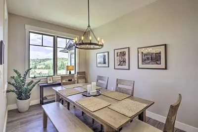 a dining room with a table and chairs and a window at Winter Park Condo with Fireplace - 4 Mi to Slopes! in Winter Park