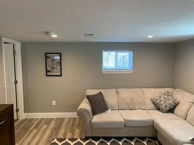 a living room with a couch and a window at DIA HideAway -2BR, 15 min from DIA DT, Anschutz MD in Commerce City