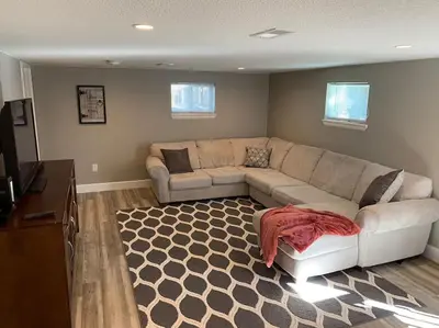a living room with a couch and a rug at DIA HideAway -2BR, 15 min from DIA DT, Anschutz MD in Commerce City