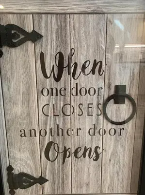 a sign on a wooden door that reads when and door closes and another door opens at DIA HideAway -2BR, 15 min from DIA DT, Anschutz MD in Commerce City