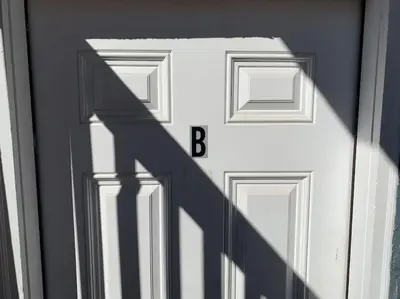 a shadow of a door with the letter b on it at DIA HideAway -2BR, 15 min from DIA DT, Anschutz MD in Commerce City