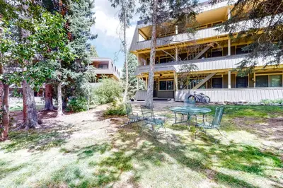 a patio with a table and chairs in front of a building at Hi Country Haus 11-2 in Winter Park