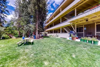a building with a yard with benches in front of it at Hi Country Haus 11-2 in Winter Park